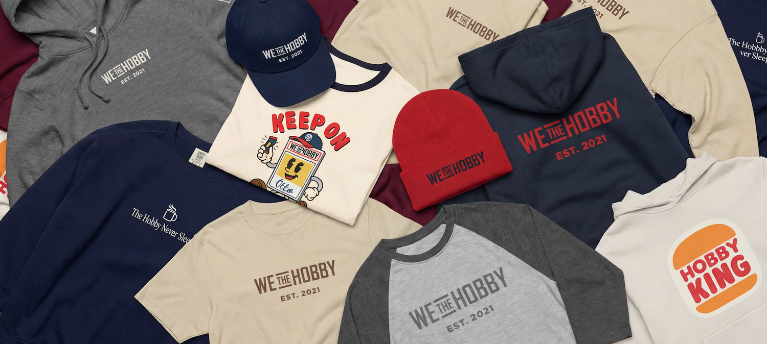 Collection of 'WETHEHOBBY' branded clothing and accessories on a flat surface.
